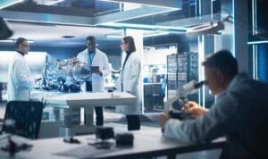 Scientists examining jet engine in lab.