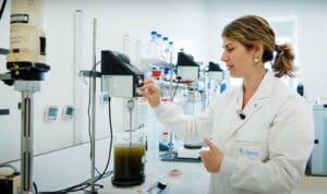 Scientist mixing liquid in lab.