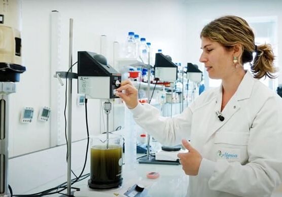 Screenshot Scientist mixing liquid in lab.